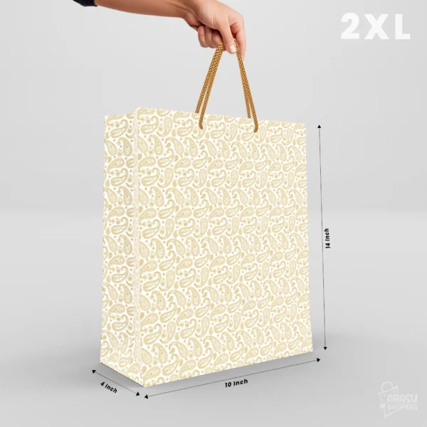 Cream return gift bags with traditional gold mango paisley pattern and golden rope handles, shown in sizes XS to 3XL.