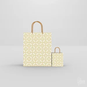 Two white paper return gift bags in small and large sizes with gold geometric Sikku Kolam print and golden rope handles.