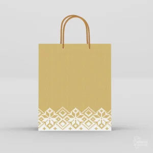 Golden paper gift bag with white traditional border motif and braided rope handles.