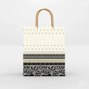 Traditional cream and black printed paper gift bag featuring floral paisley border art and twisted golden rope handles