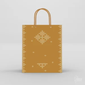 Warm mustard ochre kolam return gift bags with traditional white geometric kolam art and braided golden rope handles